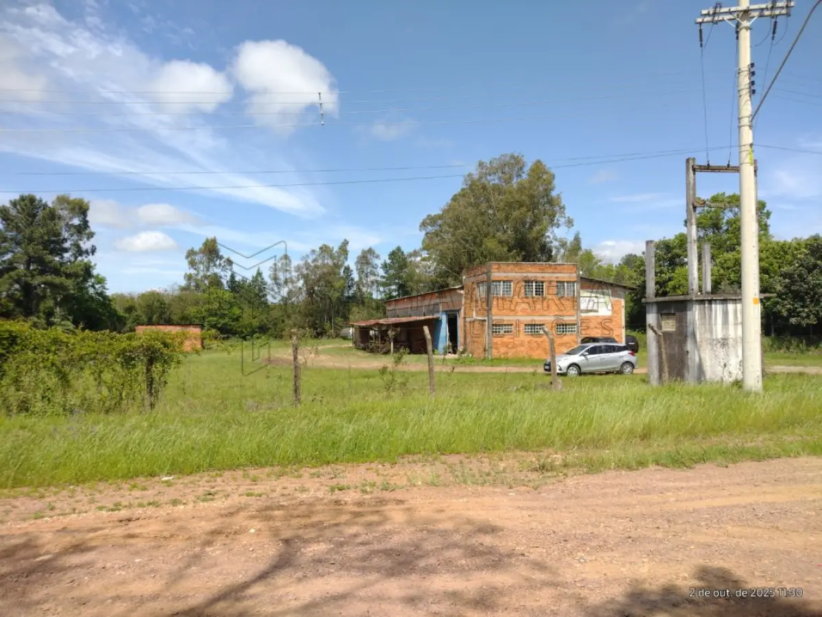 LOTE 001 - Um terreno com aproximadamente 7.000,00m² no Distrito Industrial de Santiago/RS, na Rua Alberto Bochi, antiga rua C, nº 156, possuindo uma área construída com aproximadamente 420,00m². Localizado no lado direito para quem observa da BR 287, distando 110m da esquina com a rua A; medindo pela frente 55m; lado direito mede 144,50m; lado esquerdo mede 113,90m e pelos fundos com uma sanga, mede 63m. Matriculado sob n° 28.317 do CRI de Santiago/RS.