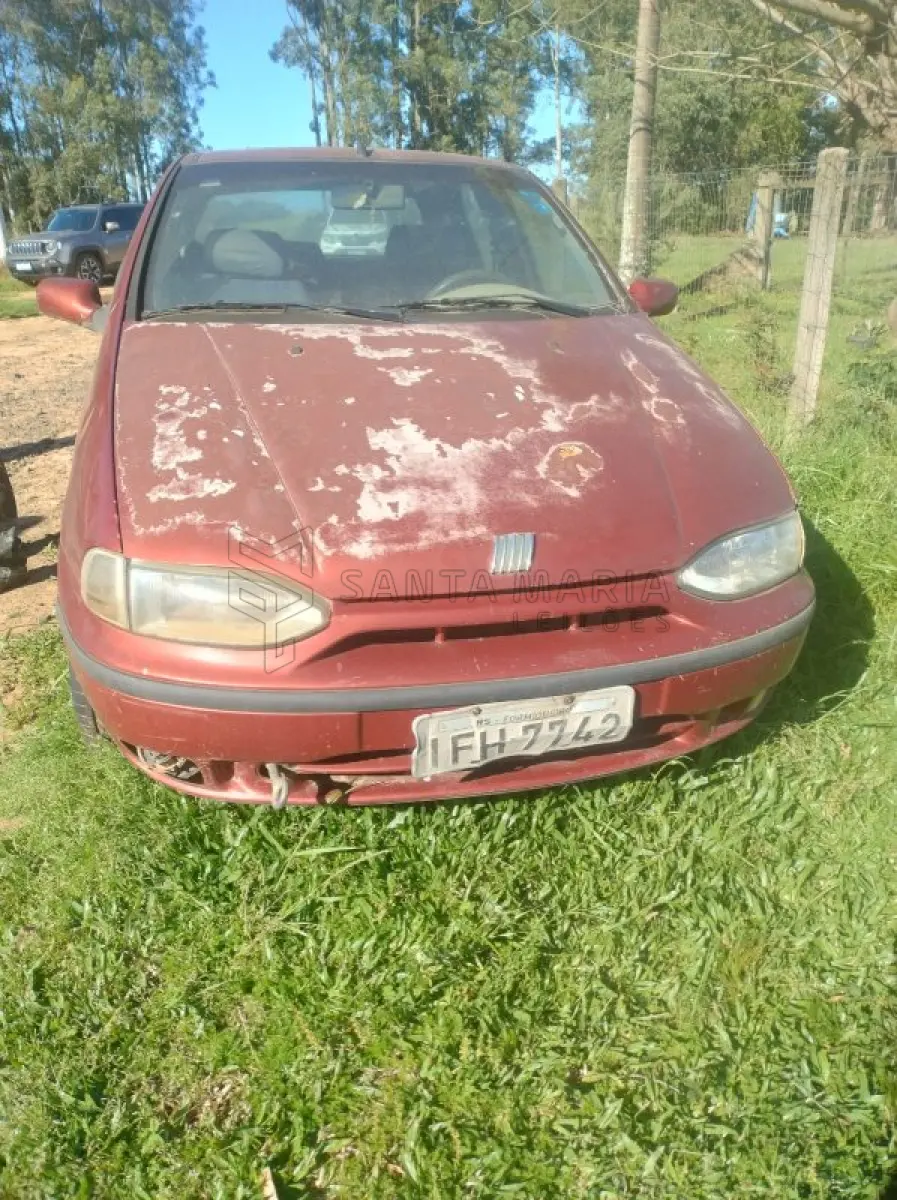 LOTE 001 - Veículo FIAT/PALIO EDX, ano/modelo 1996/1996, placas IFH7742, RENAVAM 659894483, na cor vermelha, com diversas partes da lataria apodrecidas, aparentando estar sem rodar há muito tempo. Localização do bem: Deposito da Exequente em Itaara/RS.